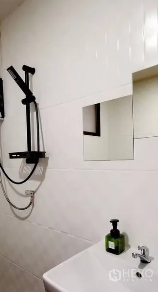 Townhouse for rent in Watthana, Bangkok - Close-up of modern shower set and sink on a white tiled wall.