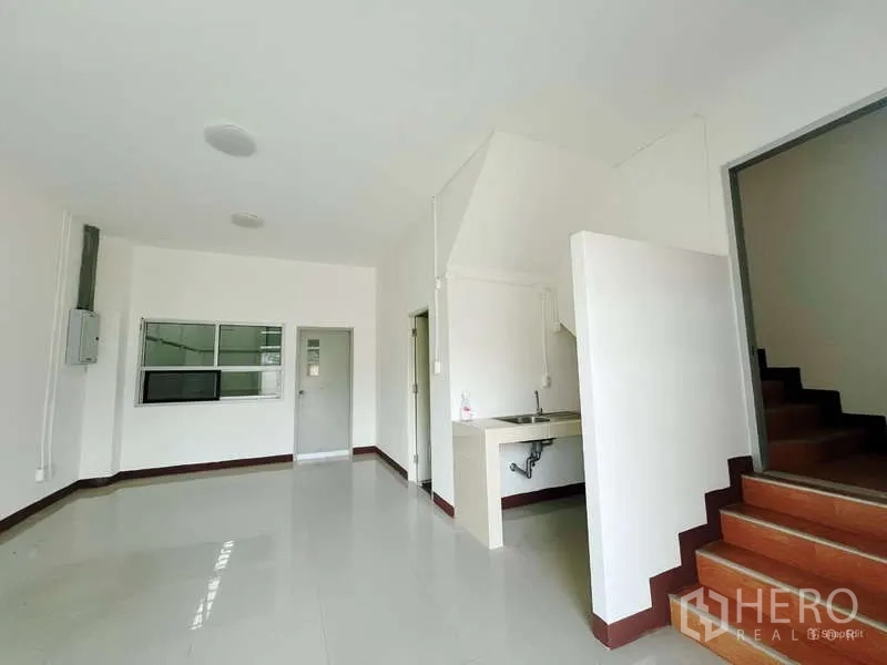 Factory for rent in Mueang Samut Sakhon, Samut Sakhon - Ground-floor office area with tiled flooring, sink, and staircase leading to the mezzanine offices.