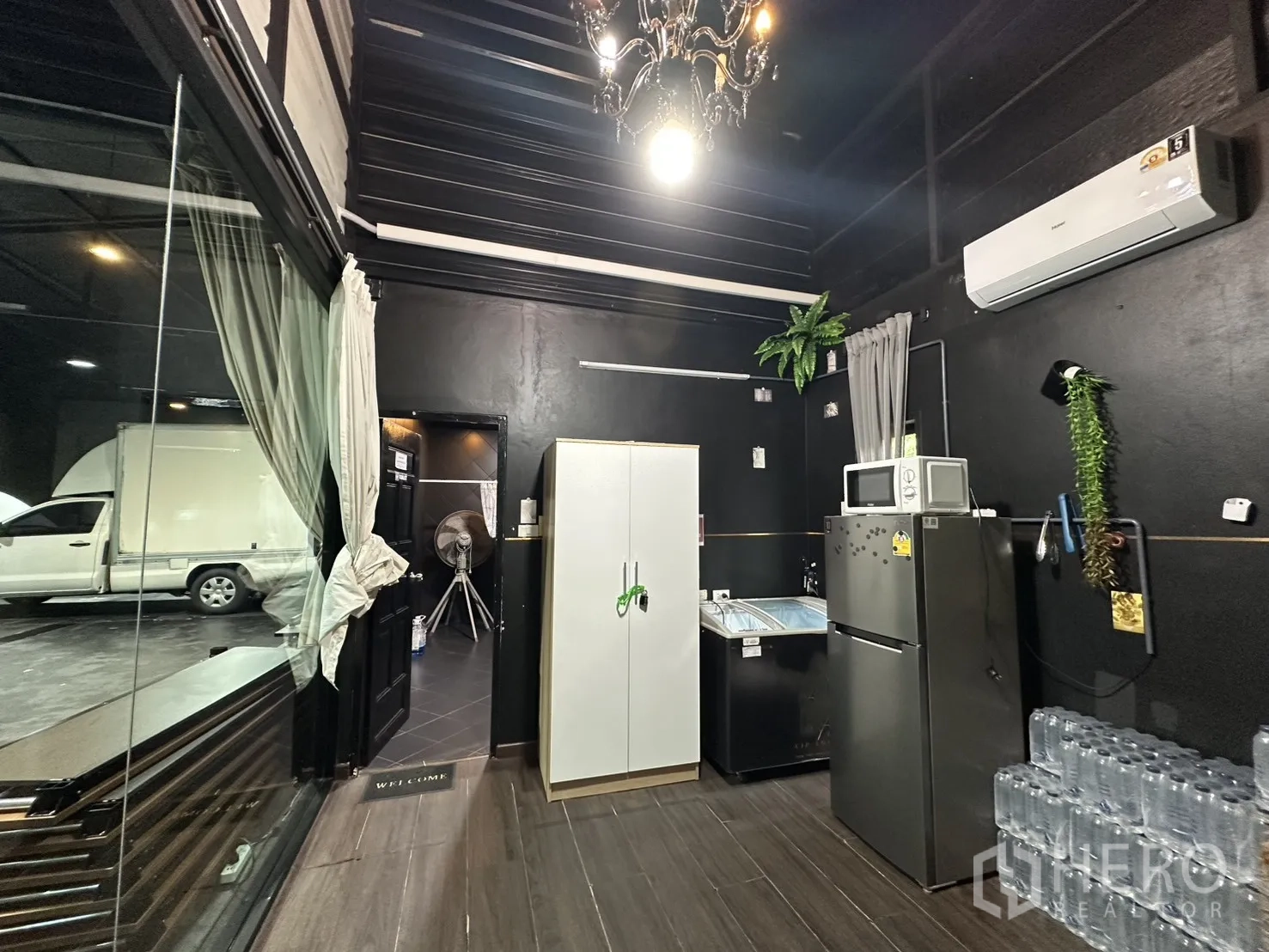 Warehouse for rent in Phra Khanong, Bangkok - Pantry with refrigerator, cabinets, and air-conditioning unit.