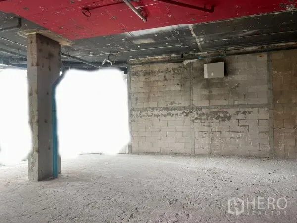 Retail Space for rent in Watthana, Bangkok - Shell retail interior with exposed red ceiling, concrete column and block walls ready for fit‑out.