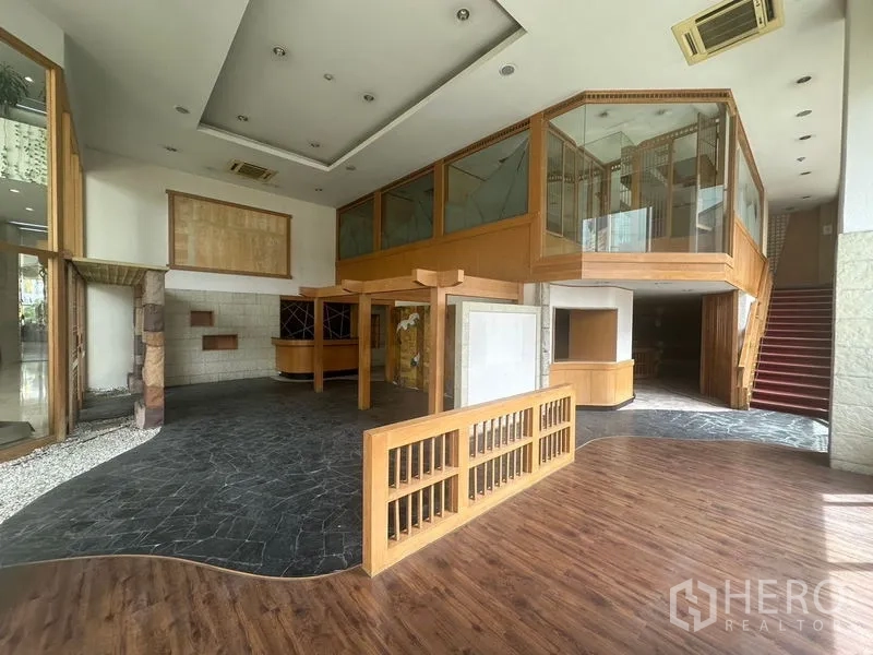 Retail Space for rent in Bang Rak, Bangkok - Expansive open space with curved wooden railings and stone tiles.