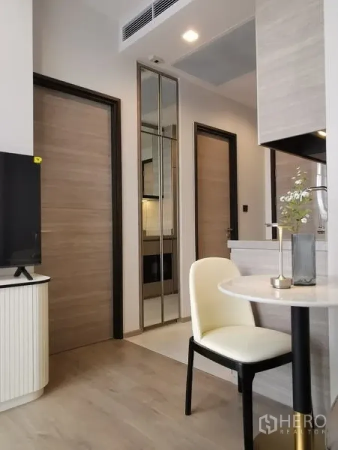 Condominium for rent - Another angle of the corridor and dining nook showing wood doors, mirrored panels and kitchen cabinets.