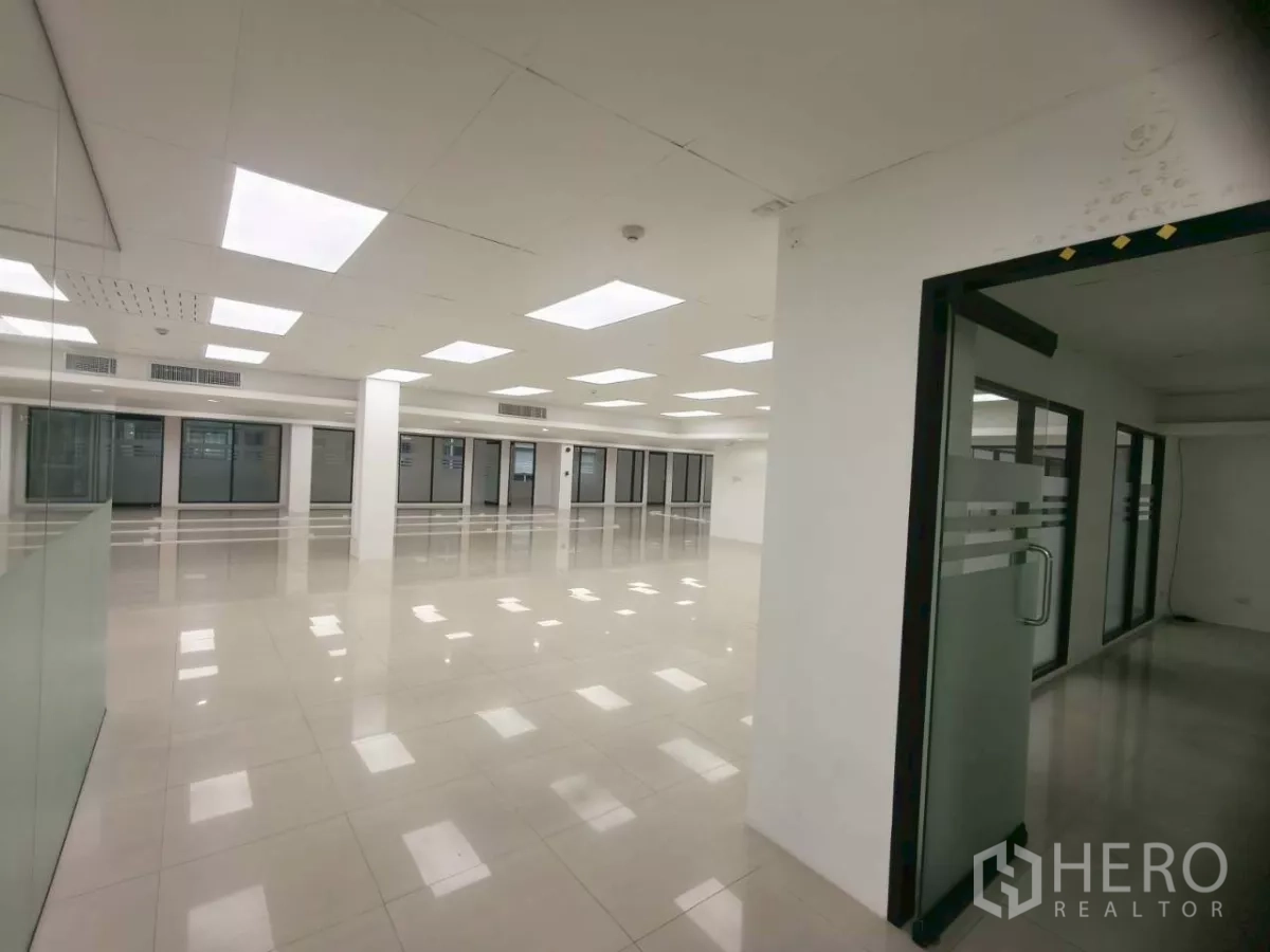 Office Space for rent in Chatuchak, Bangkok - View from entrance across large tiled office with glass doors and partitions