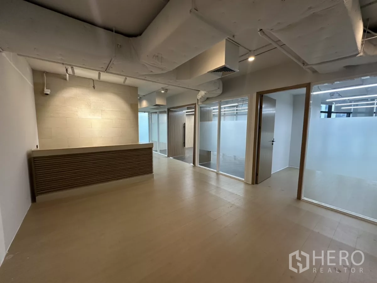 Office Space for rent in Watthana, Bangkok - Reception lobby with built-in counter and adjacent glass offices.