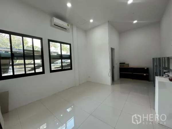 Home Office for rent in Phra Khanong, Bangkok - Bright white office room with tiled floor, split air-conditioner and two black-framed windows.