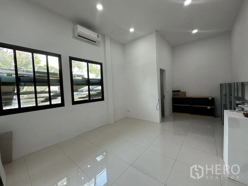 Home Office for rent in Phra Khanong, Bangkok - Bright white office room with tiled floor, split air-conditioner and two black-framed windows.