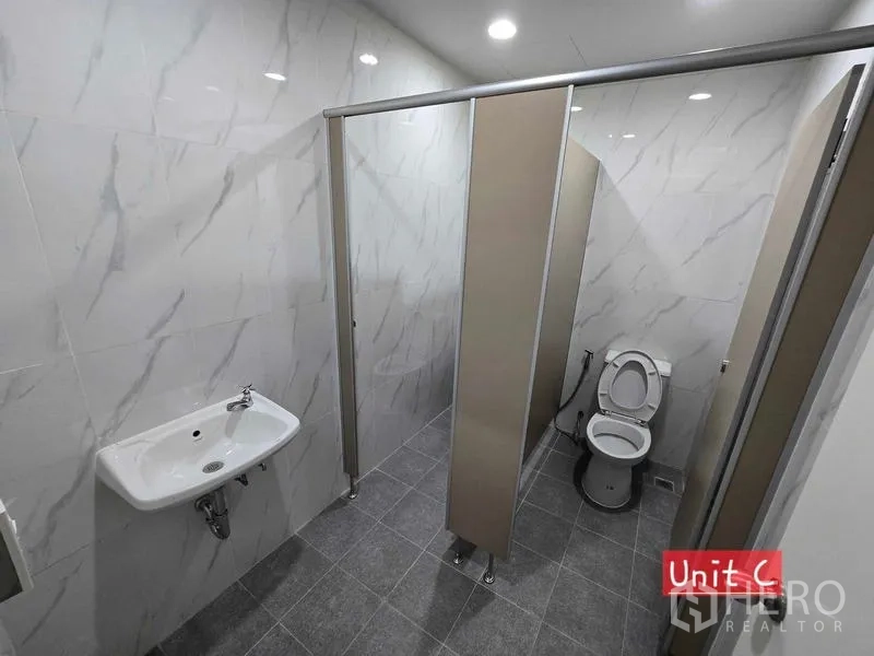 Home Office for rent in Chatuchak, Bangkok - Newly tiled restroom with partitions, wall sink, and a toilet cubicle.