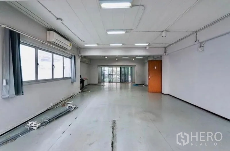 Home Office for rent or sale - Spacious open-plan office floor with bright windows, ceiling lights, air-conditioning and sliding glass doors.