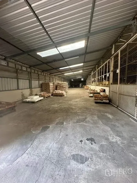 货栈 出租在Yan Nawa, Bangkok - 仓库长走道，采光板天窗、混凝土地面与网格分区。