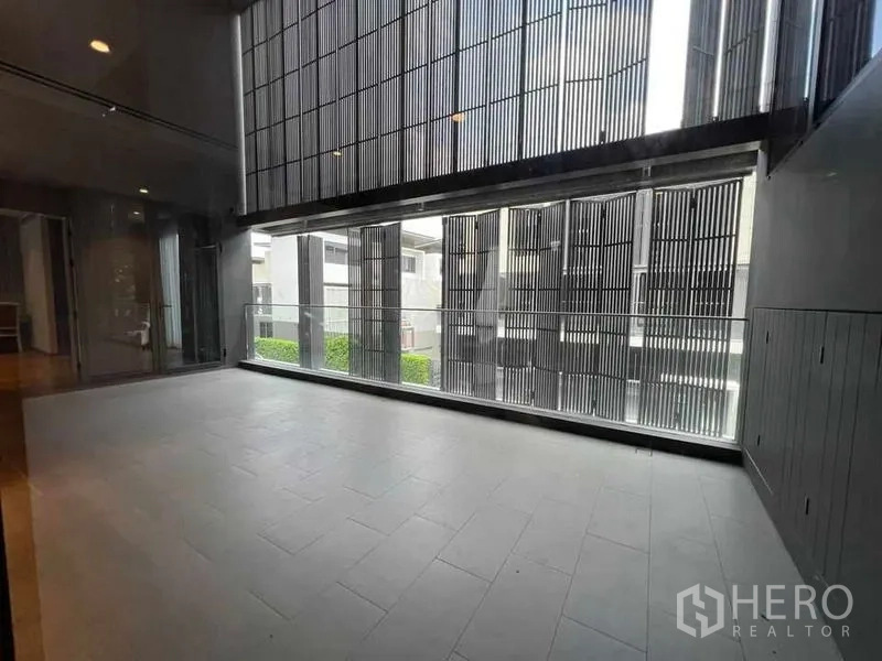 Detached House for sale in Suan Luang, Bangkok - Expansive balcony with vertical louvered screens and glass railing.