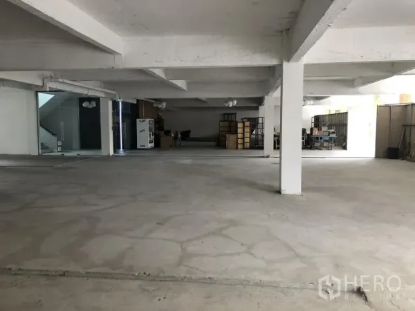 Office Space for rent in Khlong Toei, Bangkok - Ground-floor office zone with glass entry, shelving and open workspace areas.