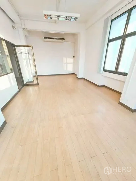 Office Space for rent in Bang Na, Bangkok - Private office room with glass door, big window and wood-style flooring.