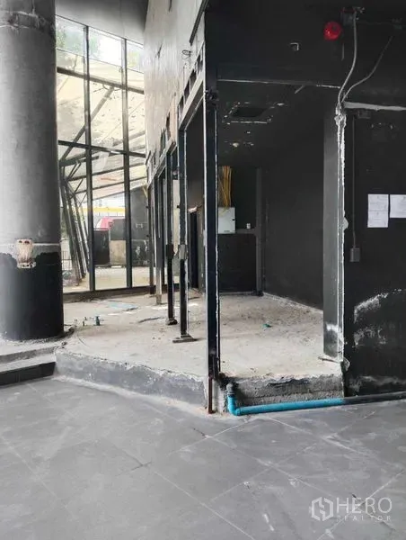 Retail Space for rent in Watthana, Bangkok - Open-plan retail unit under renovation with partial partitions, exposed utilities and black walls.