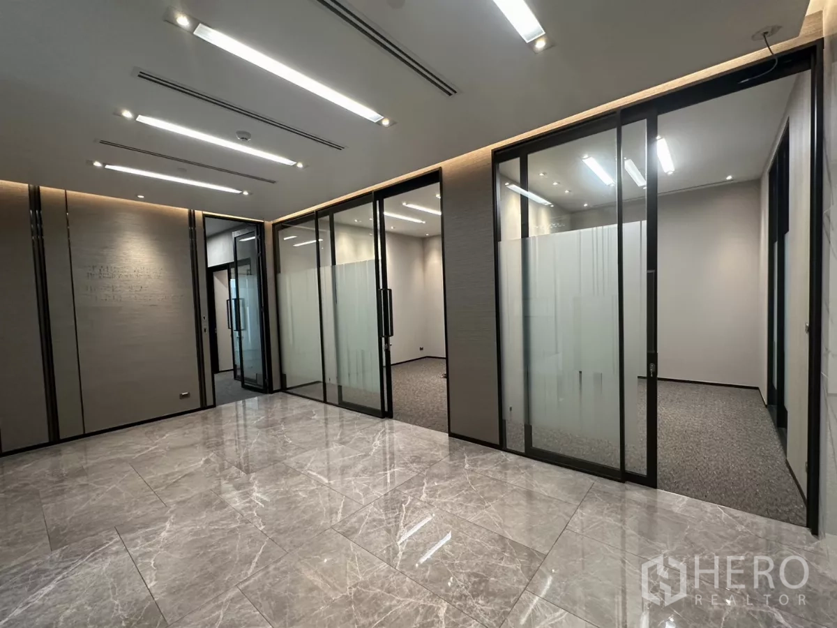 Office Space for rent in Watthana, Bangkok - Bright lobby area with glossy stone tiles and sliding glass meeting rooms.