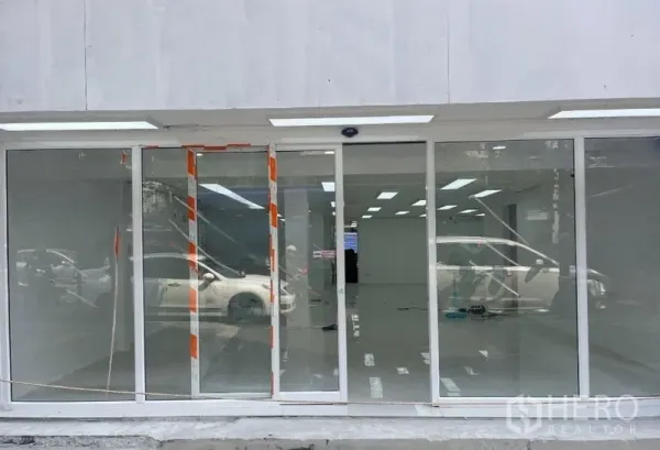 Retail Space for rent in Khlong Toei, Bangkok - Wide glass storefront with sliding doors and LED canopy lighting.