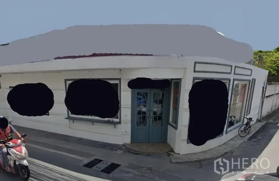 Retail Space for rent in Watthana, Bangkok - Corner retail shopfront with white facade, teal double doors and large display windows on a quiet lane.