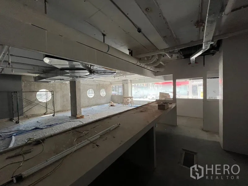 Retail Space for rent in Watthana, Bangkok - View from the service counter across the open-plan retail area toward street-facing windows.