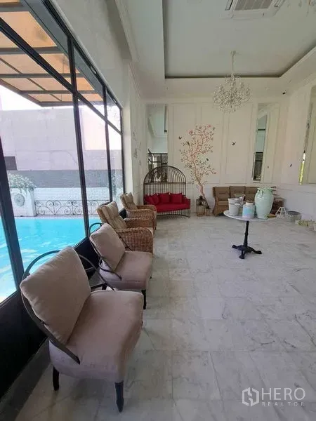 Retail Space for rent in Watthana, Bangkok - Seating area along floor-to-ceiling windows overlooking a pool.
