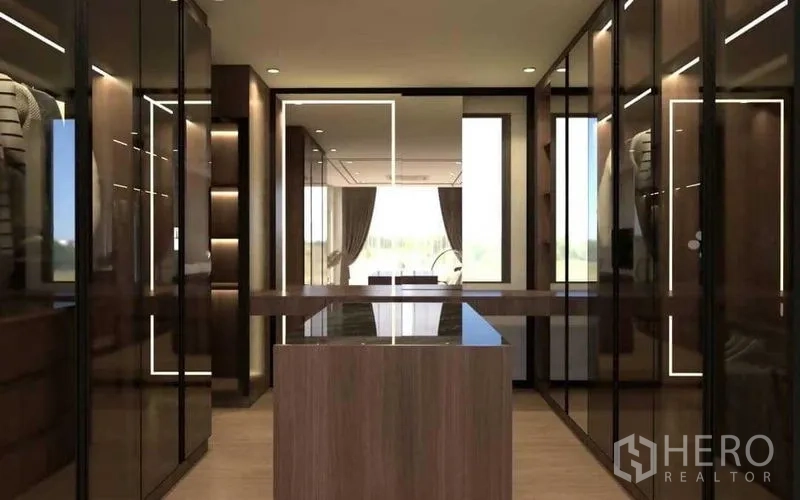 Townhouse for sale in Suan Luang, Bangkok - Walk-in closet with glass wardrobes, wood island and LED lighting.