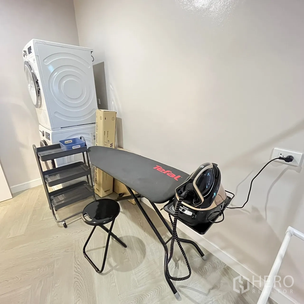 Detached House for rent or sale in Bang Khen, Bangkok - Laundry zone with stacked washer‑dryer and ironing board.