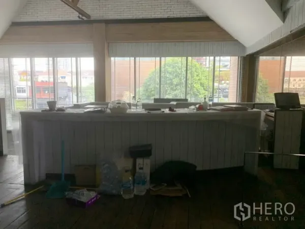 Retail Space for rent in Watthana, Bangkok - Open-plan upper floor with a long service counter and panoramic windows overlooking the Thonglor area.
