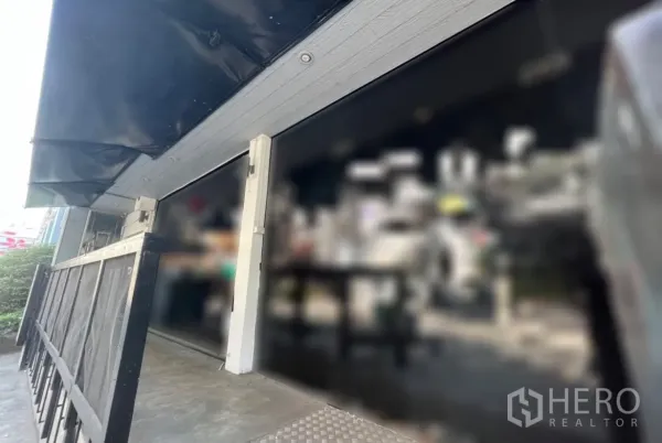 Retail Space for rent in Watthana, Bangkok - Close-up of glass shopfront with black awning and ramped entrance.