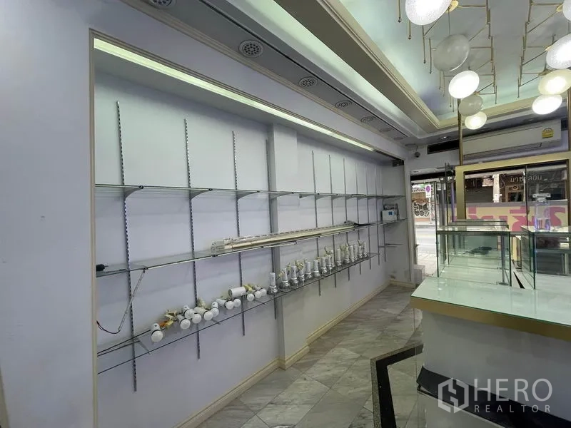 Shophouse for rent in Bang Rak, Bangkok - Front display wall with adjustable glass shelves beside the shop window.