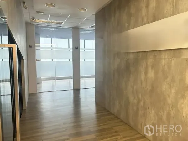Office Space for rent - Bright office corridor with wood flooring and frosted glass partitions