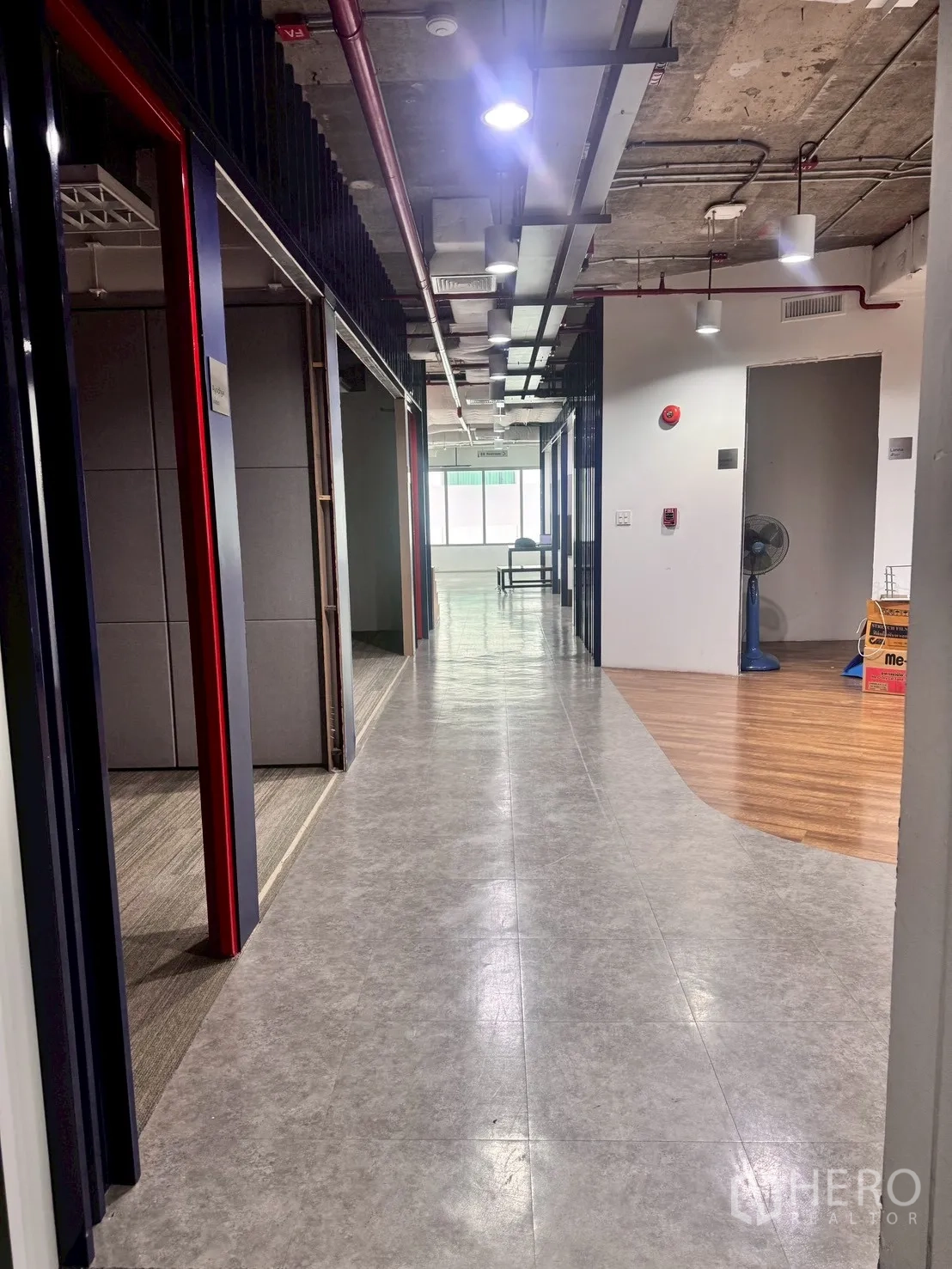 Office Space for rent in Watthana, Bangkok - Hallway with meeting rooms and ceiling-mounted lights along the corridor.