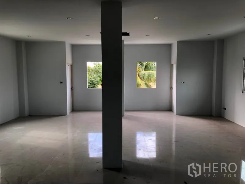 Factory for rent in Khlong Luang, Pathum Thani - Upper-floor office space with glossy tiles and windows overlooking greenery.