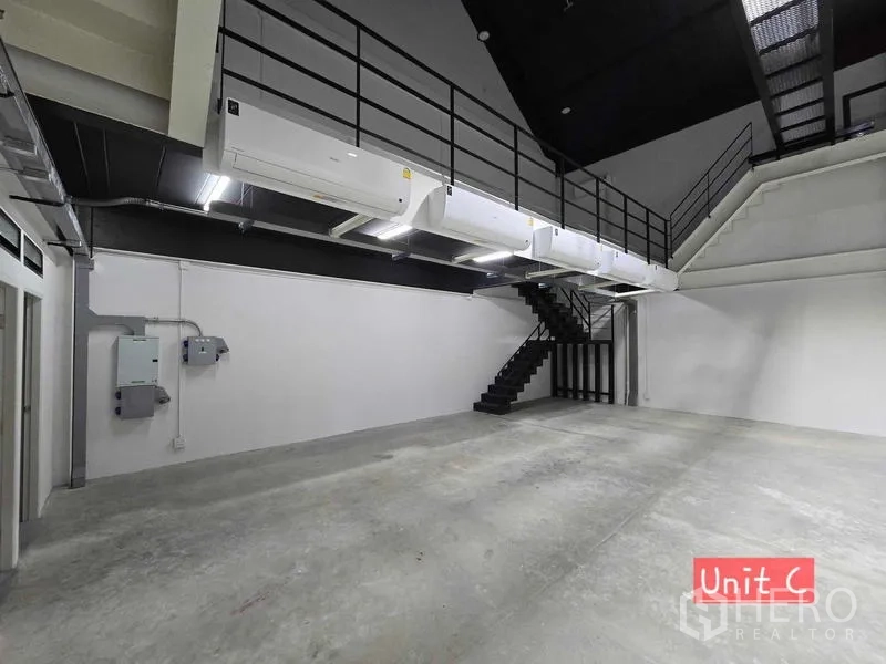 Home Office for rent in Chatuchak, Bangkok - Industrial hall showing air-conditioning units, electrical panels, and a metal staircase.