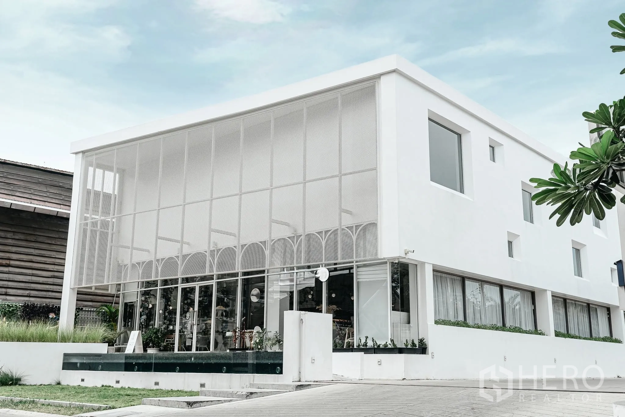 Office Space for rent in Bang Kapi, Bangkok - Modern white two-story office building with large glass facade and landscaped frontage.