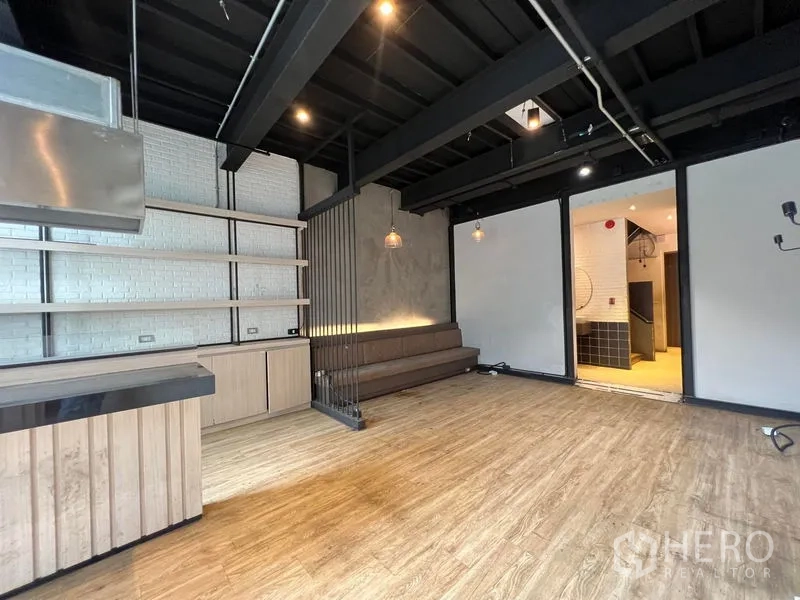 Shophouse for rent - Retail zone with shelving, sofa bench seating and access to the back section.