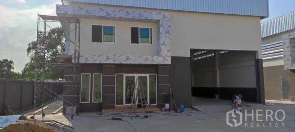 Warehouse for rent in Bang Khun Thian, Bangkok - Modern warehouse exterior with two-storey office facade, glass doors and a wide loading bay.