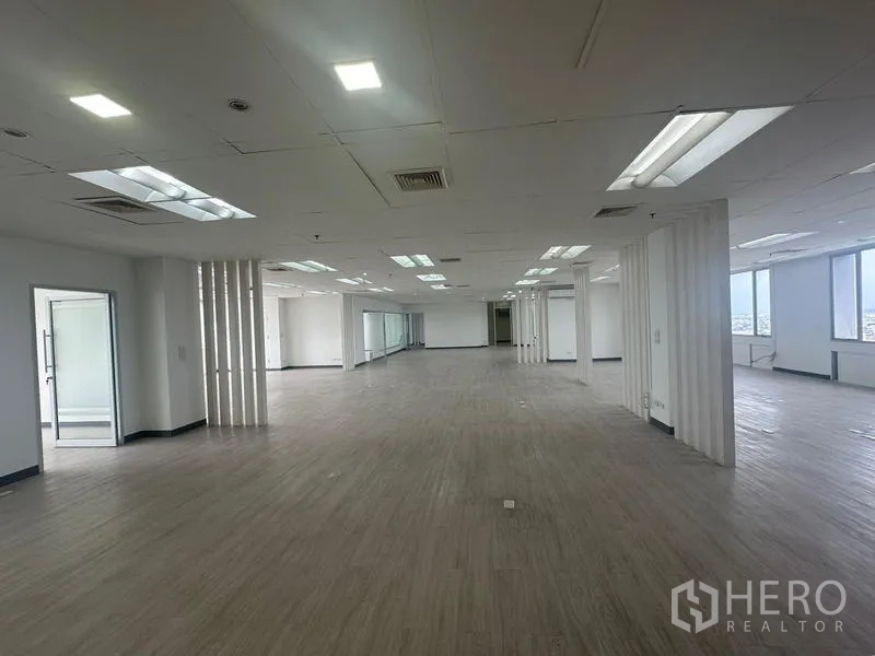 Office Space for rent - Vast open-plan office with suspended ceiling lights and multiple window bays.