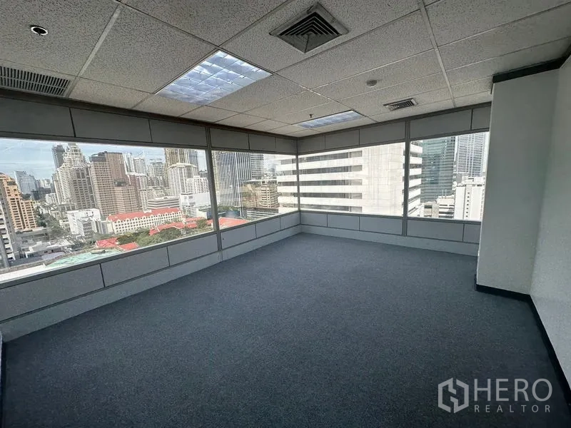 Office Space for rent in Pathum Wan, Bangkok - Corner room with wraparound glazing and skyline views of high-rise buildings.