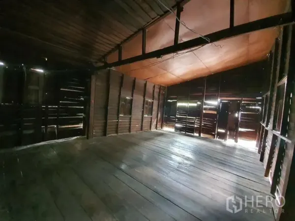 Detached House for rent in Sathon, Bangkok - Spacious open-plan upper room with sloped ceiling and dark timber walls.