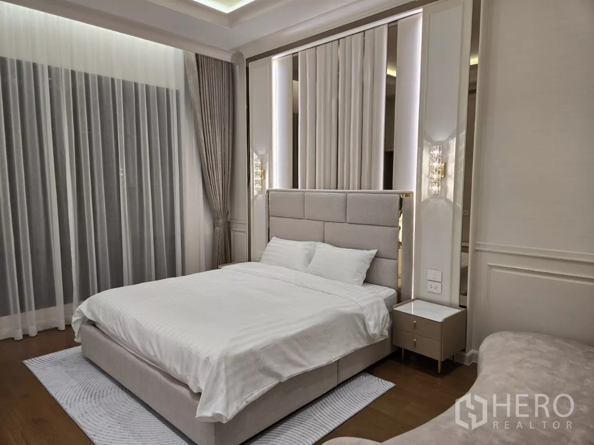 Detached House for rent or sale in Bang Kapi, Bangkok - Bedroom with upholstered headboard, bedside tables and tall drapes.