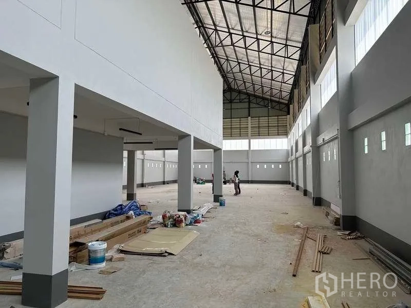 工厂 出售在Khlong Luang, Pathum Thani - 宽敞生产区，柱网与长窗，地面放置装修材料。