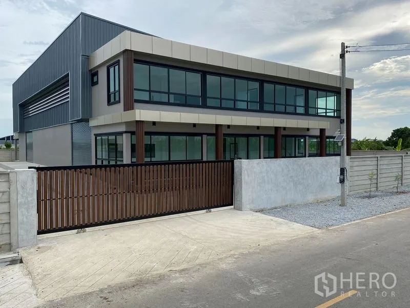 Warehouse for rent or sale in Bang Len, Nakhon Pathom - Modern two-storey warehouse with glass-front office, secure gate and perimeter wall.