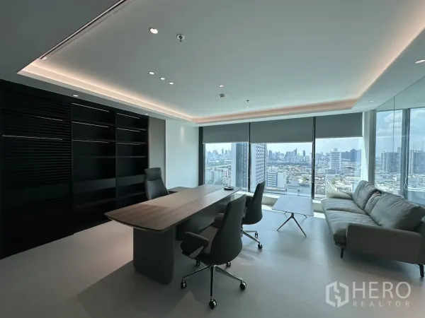 Office Space for rent in Din Daeng, Bangkok - Executive office with desk, shelving, sofa, and panoramic skyline views from large windows.