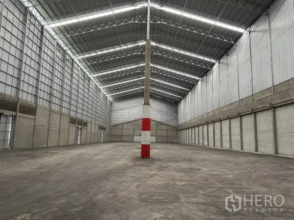 Warehouse for rent in Mueang Pathum Thani, Pathum Thani - Deep warehouse bay showing multiple access doors and ventilated side panels for airflow.