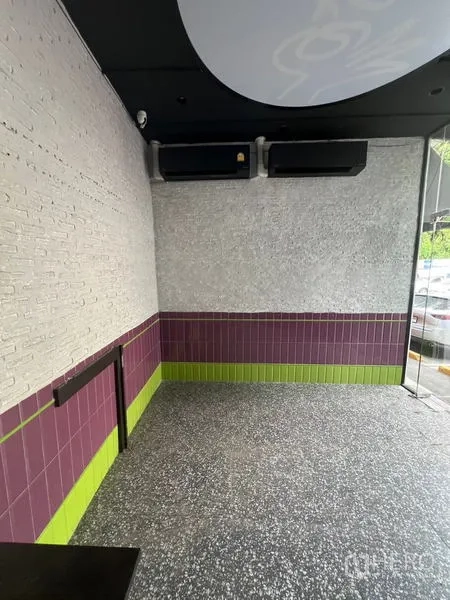 Retail Space for rent in Watthana, Bangkok - Compact retail zone with feature brick wall, corner glazing, and ample natural light.