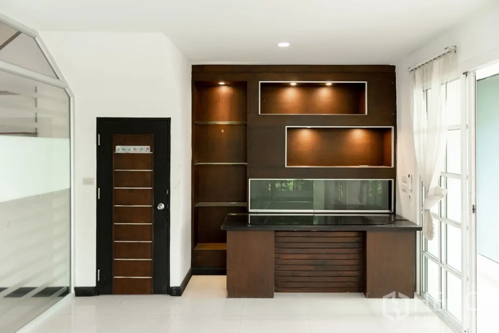 Home Office for rent in Lat Phrao, Bangkok - Illuminated built-in shelving and work counter in the office area.