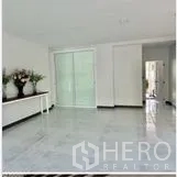 Home Office for rent in Wang Thonglang, Bangkok - Spacious open room with glossy tiles and sliding glass door leading to inner area.