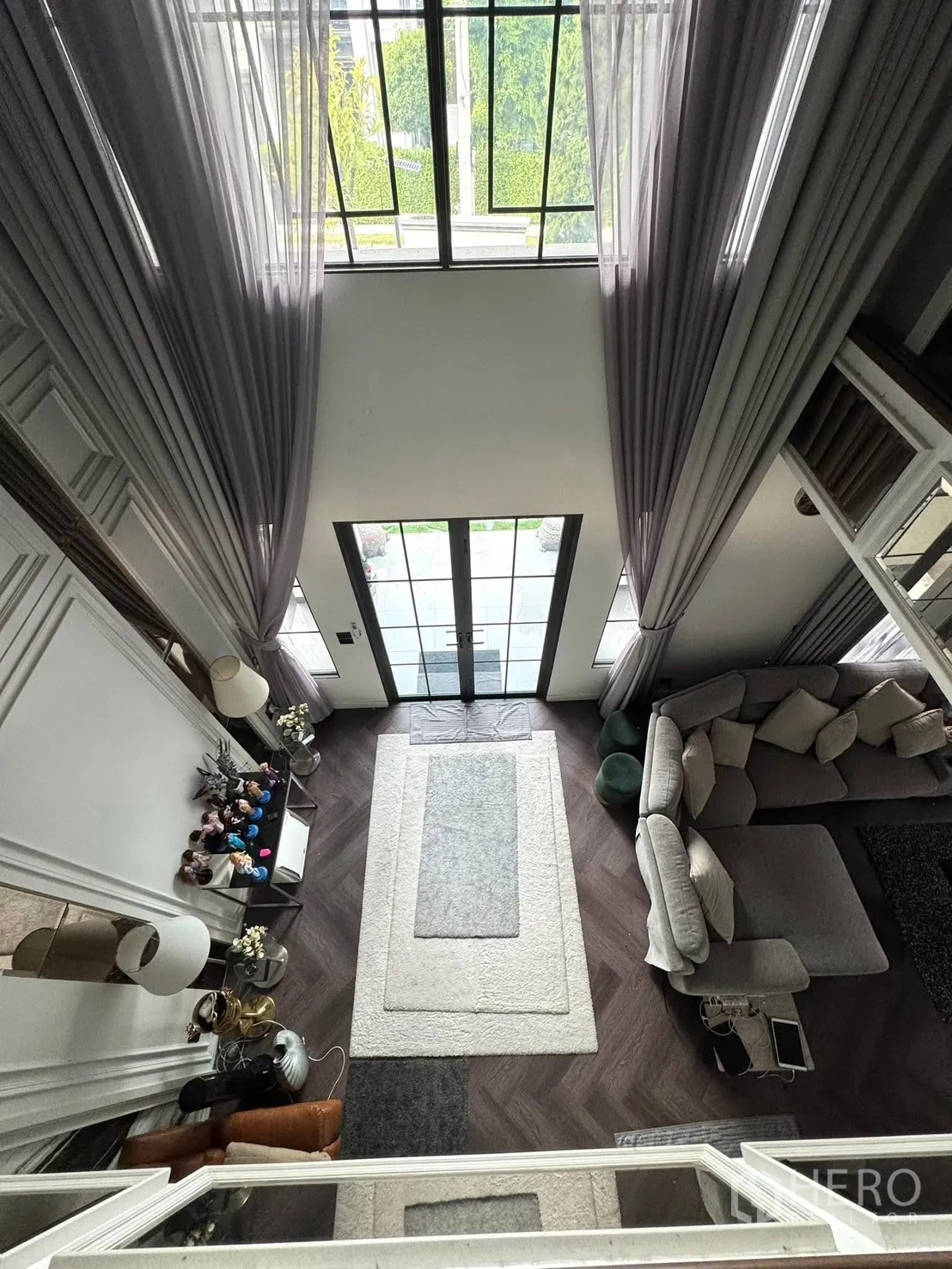 Detached House for sale in Mueang Pathum Thani, Pathum Thani - Aerial view from upper floor overlooking entry doors and lounge layout.