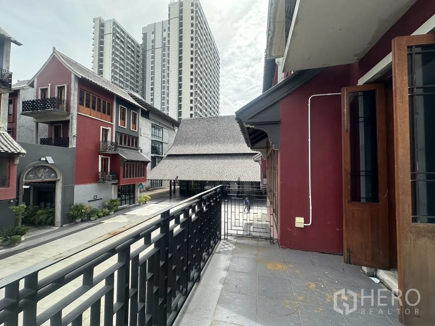 Home Office for rent in Pathum Wan, Bangkok - Balcony outlook to nearby mid-rise condo towers and surrounding red low-rise buildings.