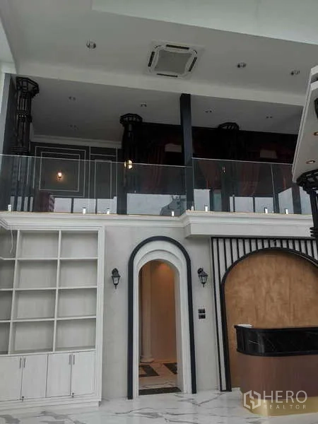 Retail Space for rent - Double-height retail area with arches and balcony.