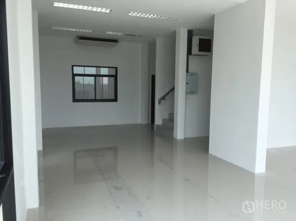 Factory for sale in Lam Luk Ka, Pathum Thani - Bright ground-floor office with polished tiles, AC unit and staircase.