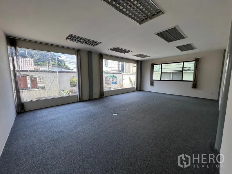 Office Space for rent - Bright corner office with multiple wide windows and carpet.